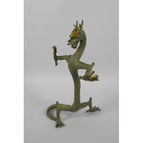 225 - A Chinese bronze figure of a dragon with gilt highlights, 24cm high