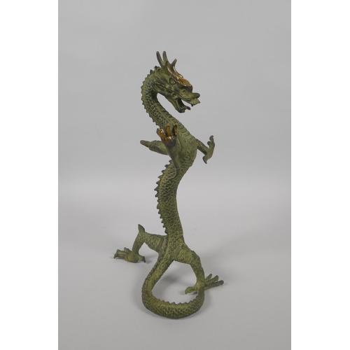 225 - A Chinese bronze figure of a dragon with gilt highlights, 24cm high