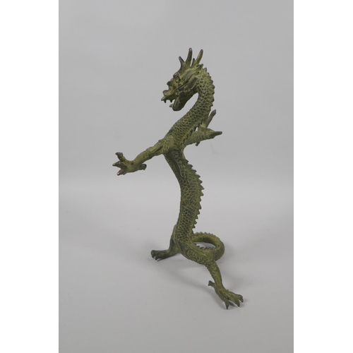 225 - A Chinese bronze figure of a dragon with gilt highlights, 24cm high