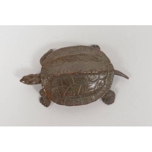 228 - A Japanese style bronze okimono tortoise, with character inscriptions to the shell, 8cm long