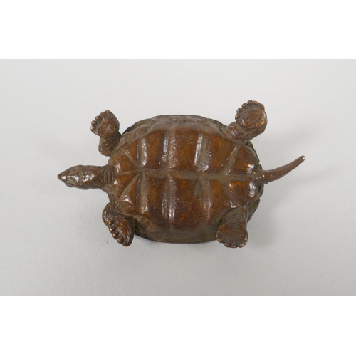 228 - A Japanese style bronze okimono tortoise, with character inscriptions to the shell, 8cm long