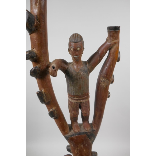 229 - An African carved hardwood lamp base in the form of a figure in a tree and an elephant, 52cm high