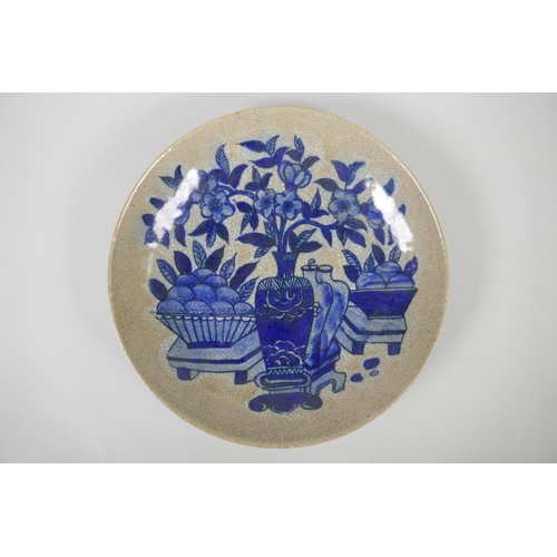 230 - A Chinese blue and white crackleware dish decorated with fruit and vases of flowers, 26cm diameter