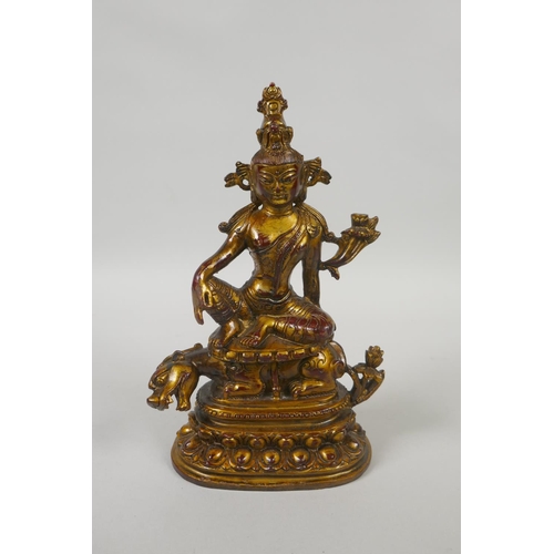 235 - A Tibetan gilt and coppered bronze figure of White Tara, 21cm high