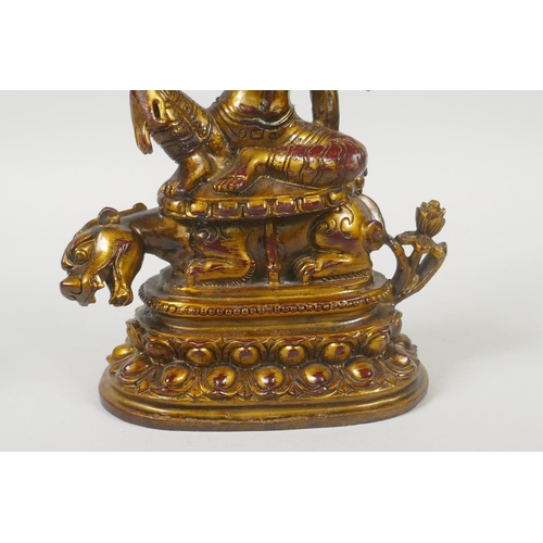 235 - A Tibetan gilt and coppered bronze figure of White Tara, 21cm high