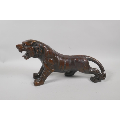 240 - A filled bronze tiger, 33cm long