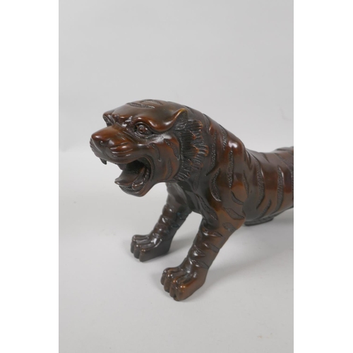 240 - A filled bronze tiger, 33cm long