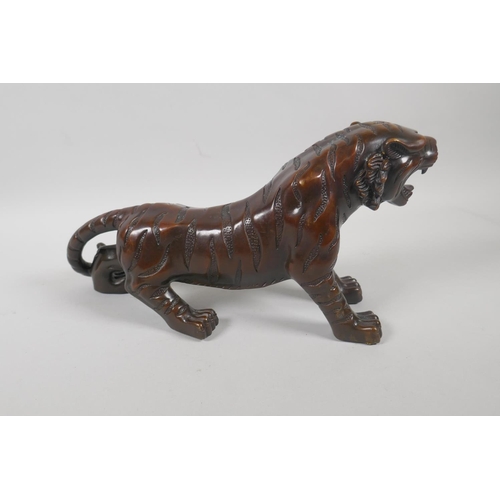 240 - A filled bronze tiger, 33cm long