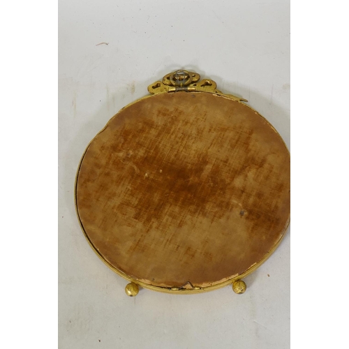 241 - An antique Empire style ormolu hanging wall mirror with bevelled glass, 28cm high