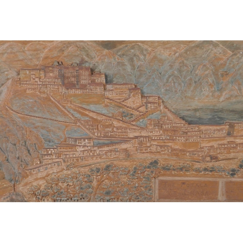 25 - A C19th Tibetan carved teak panel depicting The Potala at Lhasa, the lower right carved with an insc... 