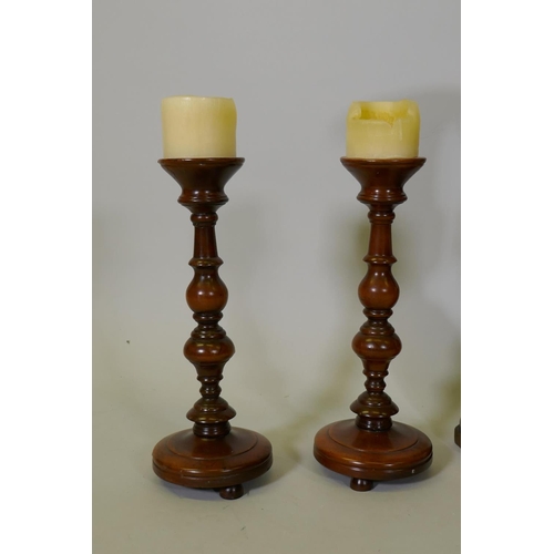 261 - A pair of turned wood decorative urns, 50cm high, and a pair of candlesticks