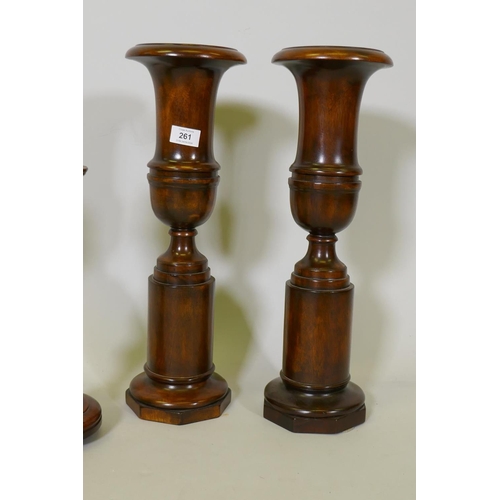 261 - A pair of turned wood decorative urns, 50cm high, and a pair of candlesticks