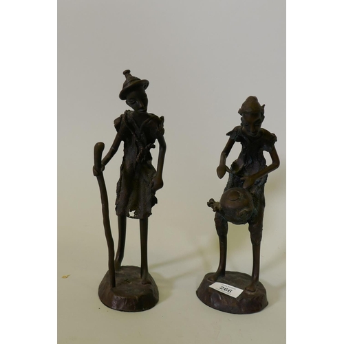 266 - A pair of African Burkina Faso bronze figures, a traveller and drum player, 28cm high