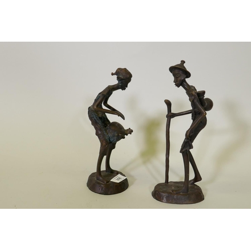 266 - A pair of African Burkina Faso bronze figures, a traveller and drum player, 28cm high