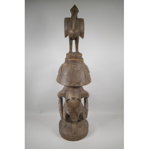 36 - An African Senufo Peoples carved wood figural offering vessel with a bird carved to the cover, 88cm ... 