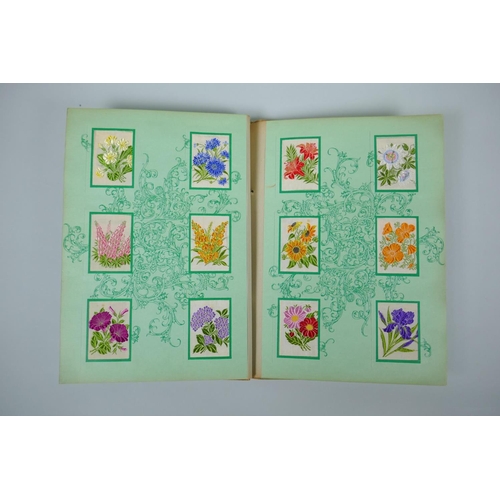 37 - Two albums of 1930s Kensitas Cigarettes silk flowers in two sizes, 5 x 7cm and 13 x 9cm