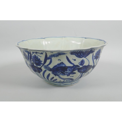 38 - A Chinese blue and white porcelain bowl with a lobed rim, decorated with carp in a lotus pond, Xuand... 