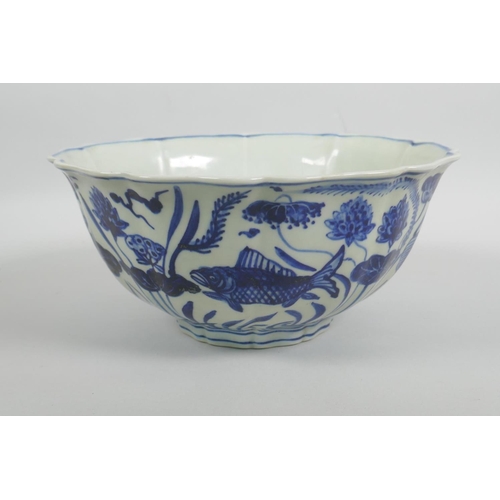 38 - A Chinese blue and white porcelain bowl with a lobed rim, decorated with carp in a lotus pond, Xuand... 