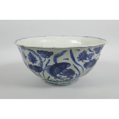 38 - A Chinese blue and white porcelain bowl with a lobed rim, decorated with carp in a lotus pond, Xuand... 