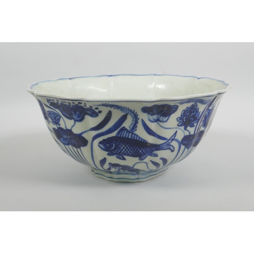 38 - A Chinese blue and white porcelain bowl with a lobed rim, decorated with carp in a lotus pond, Xuand... 