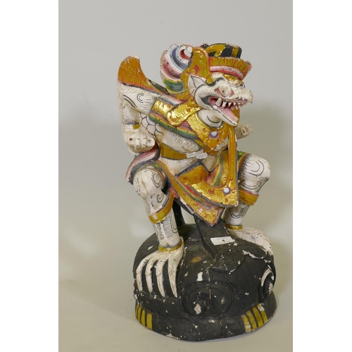 4 - A carved wood and polychrome figure of Garuda with parcel gilt decoration, 50cm high