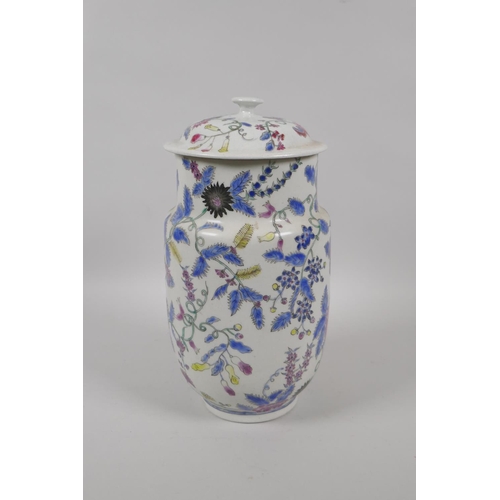 45 - An antique Oriental polychrome porcelain jar and cover, with all over floral decoration, 26cm high