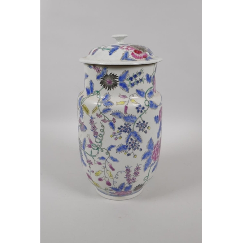 45 - An antique Oriental polychrome porcelain jar and cover, with all over floral decoration, 26cm high