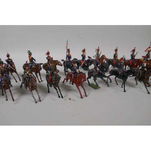 46 - Twenty five Britains mounted soldiers of various cavalry regiments, 9cm high