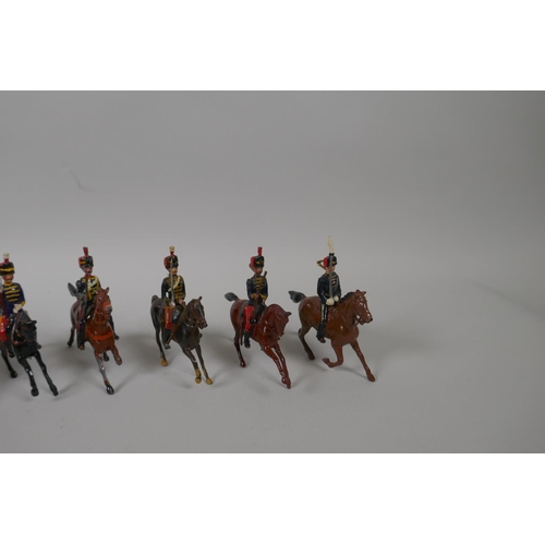 46 - Twenty five Britains mounted soldiers of various cavalry regiments, 9cm high