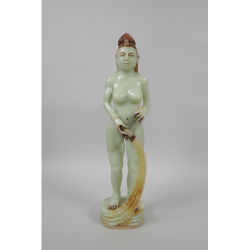 48 - An Oriental celadon green soapstone figure of a female goddess, 33cm high