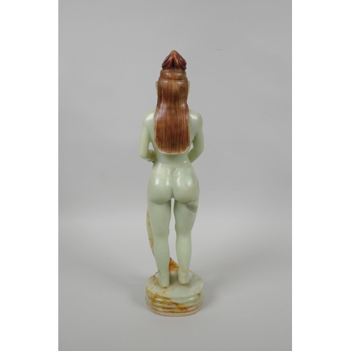 48 - An Oriental celadon green soapstone figure of a female goddess, 33cm high