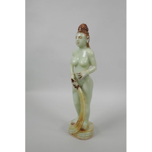 48 - An Oriental celadon green soapstone figure of a female goddess, 33cm high