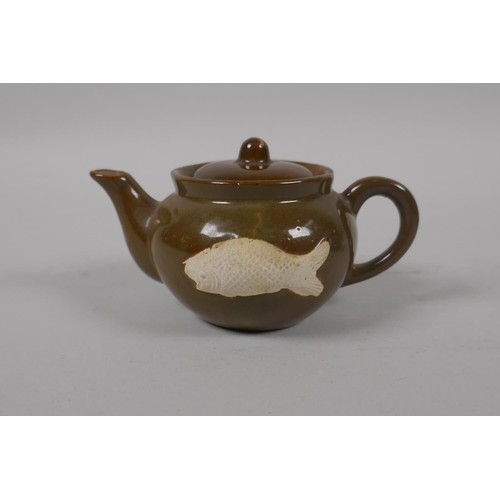 51 - A Chinese tea dust glazed porcelain teapot with raised carp decoration, and a similar blue speckle g... 