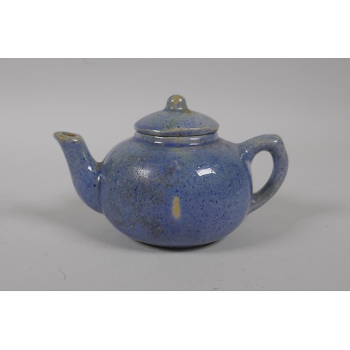 51 - A Chinese tea dust glazed porcelain teapot with raised carp decoration, and a similar blue speckle g... 