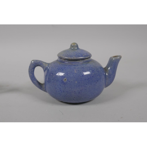 51 - A Chinese tea dust glazed porcelain teapot with raised carp decoration, and a similar blue speckle g... 