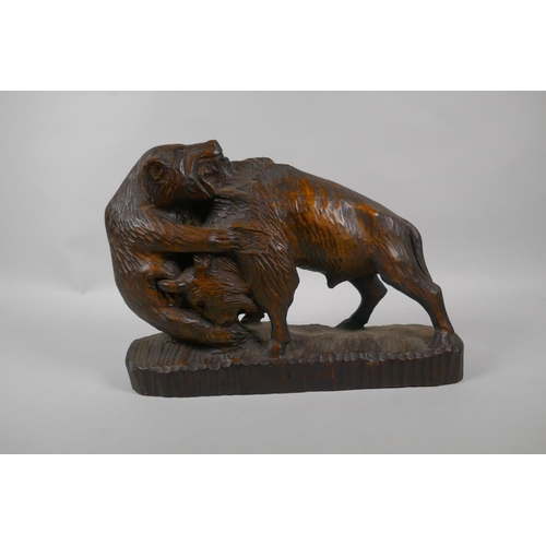 59 - A Black Forest carved boar and a bison, 36cm long, dated 1963