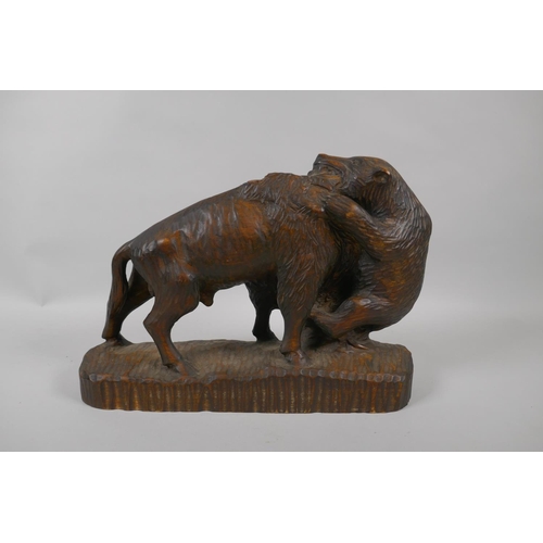 59 - A Black Forest carved boar and a bison, 36cm long, dated 1963