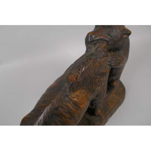 59 - A Black Forest carved boar and a bison, 36cm long, dated 1963