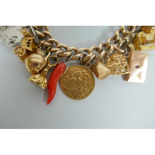 605 - A 9ct gold charm bracelet with numerous 9ct, 14ct, 18ct and 22ct gold charms, and a few yellow metal... 