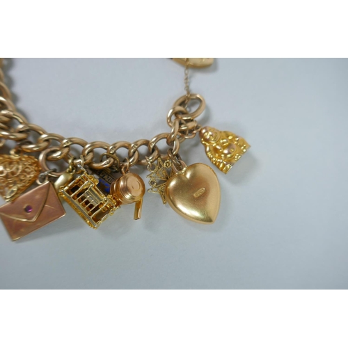 605 - A 9ct gold charm bracelet with numerous 9ct, 14ct, 18ct and 22ct gold charms, and a few yellow metal... 