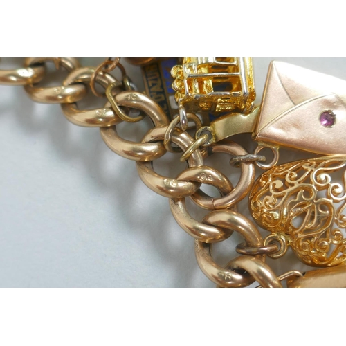 605 - A 9ct gold charm bracelet with numerous 9ct, 14ct, 18ct and 22ct gold charms, and a few yellow metal... 