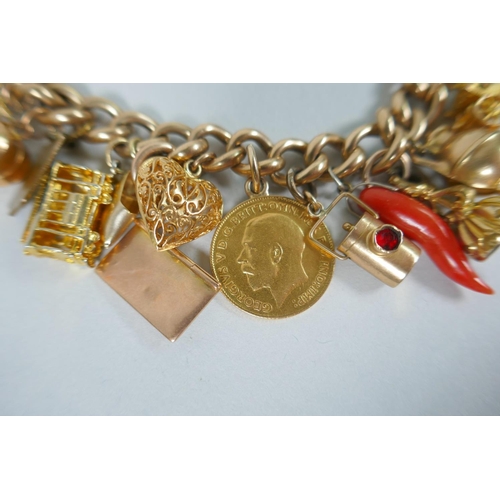 605 - A 9ct gold charm bracelet with numerous 9ct, 14ct, 18ct and 22ct gold charms, and a few yellow metal... 