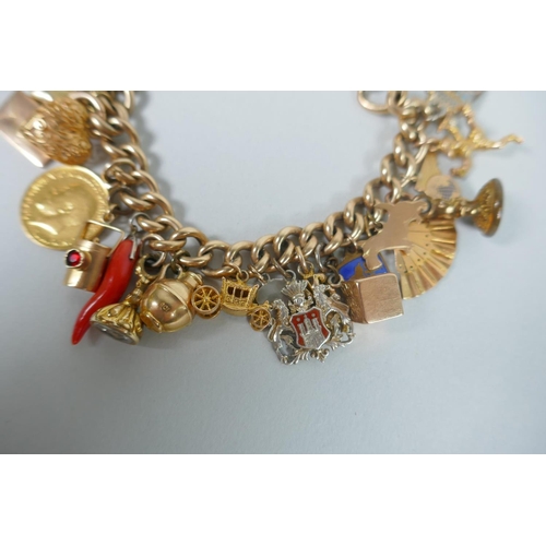 605 - A 9ct gold charm bracelet with numerous 9ct, 14ct, 18ct and 22ct gold charms, and a few yellow metal... 