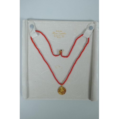 609 - An Italian natural red seed coral and 18ct gold medallion pendant necklace in the form of a 1655 Gen... 