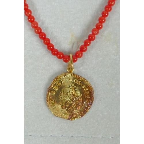 609 - An Italian natural red seed coral and 18ct gold medallion pendant necklace in the form of a 1655 Gen... 