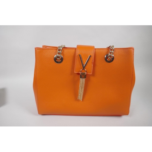 61 - A Mario Valentino 'Divine' handbag and branded protective bag, together with a leather Osprey purse ... 