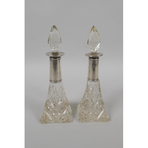 610 - A pair of hallmarked silver topped cut glass scent bottles, marks rubbed, 15cm high