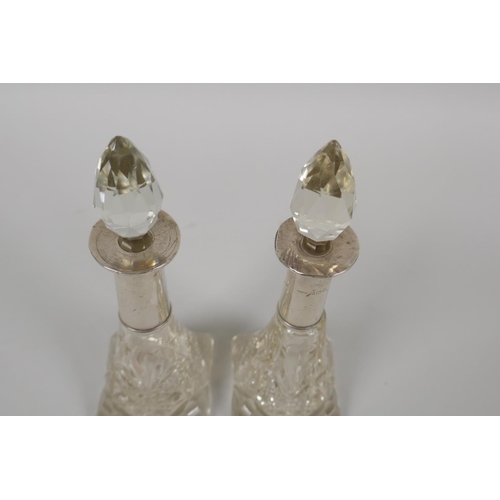 610 - A pair of hallmarked silver topped cut glass scent bottles, marks rubbed, 15cm high