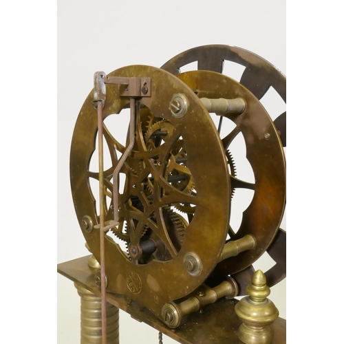 612 - A brass skeleton clock with enamel dial and single train movement, raised on a wood base with glass ... 