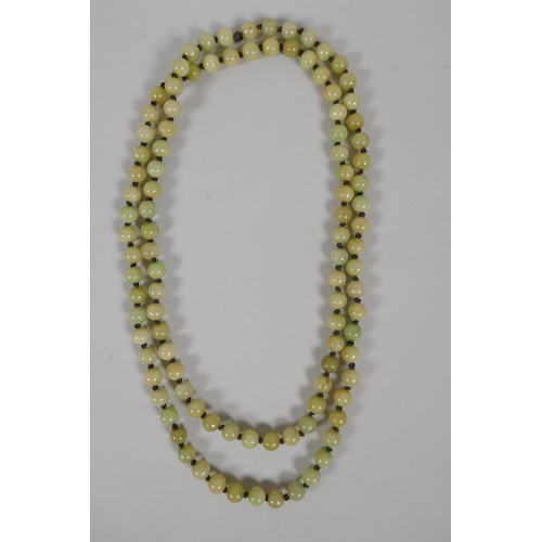 616 - A celadon jade bead necklace, 120cm